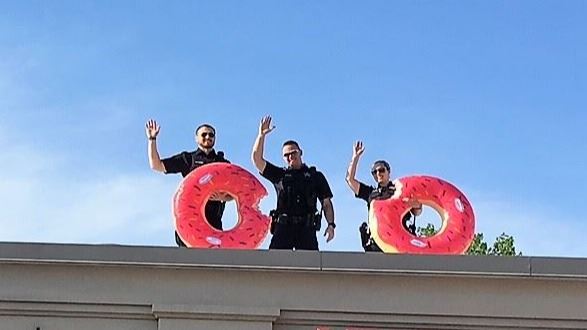 Wheaton Police waving on rooftop of Dunkin