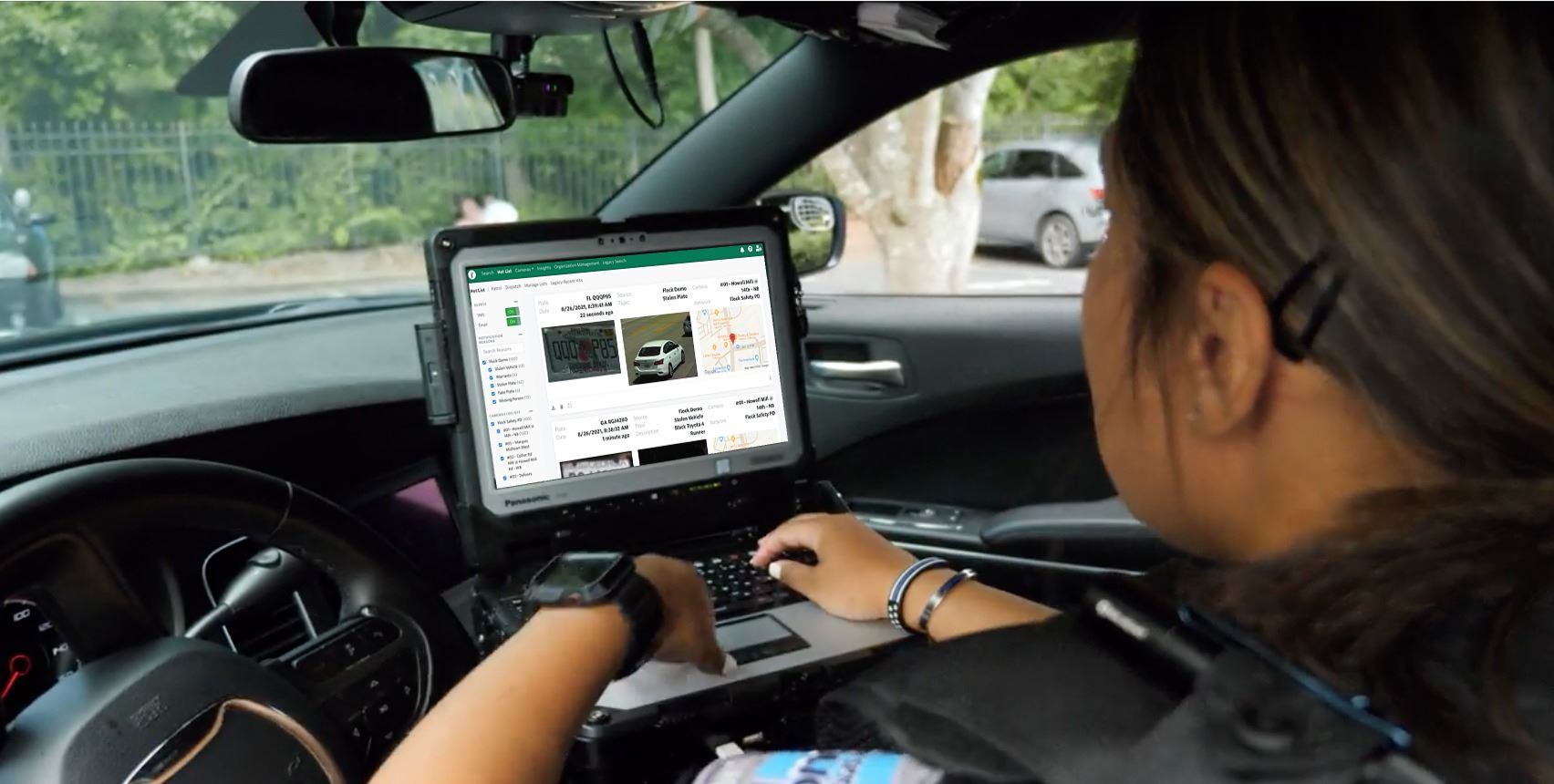 officer using flock inside police car